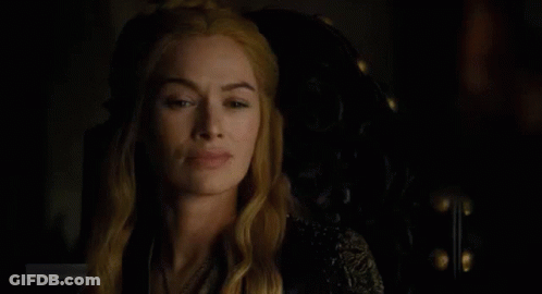 A Close Up Of A Woman Sitting In A Chair In The Dark . GIF