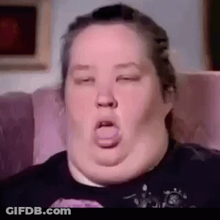 A Close Up Of A Woman Sitting On A Couch With Her Eyes Closed And Her Mouth Open . GIF