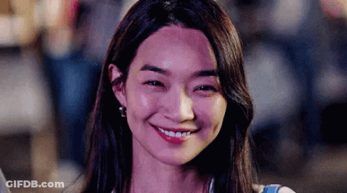 A Close Up Of A Woman Smiling With Her Eyes Closed . GIF
