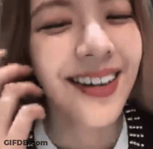 A Close Up Of A Woman Smiling With Her Eyes Closed . GIF