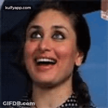 A Close Up Of A Woman Smiling With Her Mouth Open . GIF