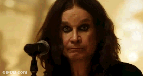 A Close Up Of A Woman Standing In Front Of A Microphone Making A Funny Face . GIF