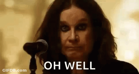 A Close Up Of A Woman Standing In Front Of A Microphone With The Words `` Oh Well '' Written On Her Face . GIF