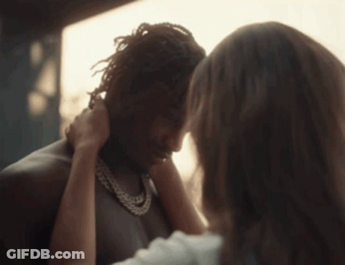 A Close Up Of A Woman Touching A Man 'S Forehead GIF