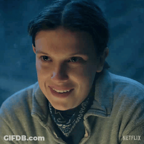 A Close Up Of A Woman Wearing A Bandana And A Netflix Logo On Her Shirt GIF