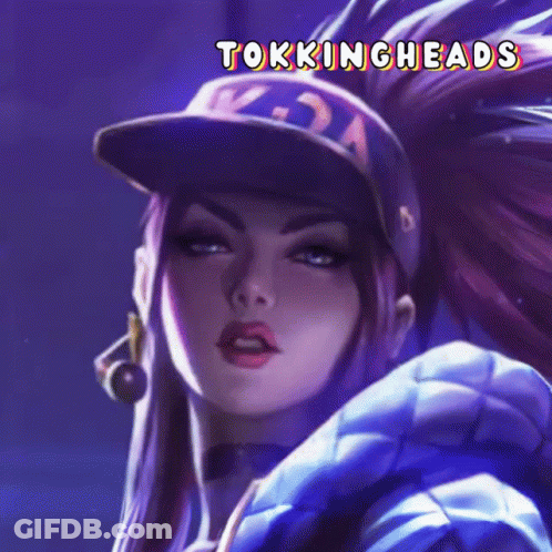 A Close Up Of A Woman Wearing A Baseball Cap With The Words Tokingheads On It GIF