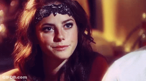 A Close Up Of A Woman Wearing A Black Headband . GIF