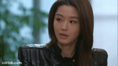 A Close Up Of A Woman Wearing A Black Leather Jacket And A Black Shirt . GIF