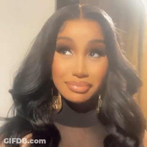 A Close Up Of A Woman Wearing A Black Turtleneck And Gold Earrings . GIF