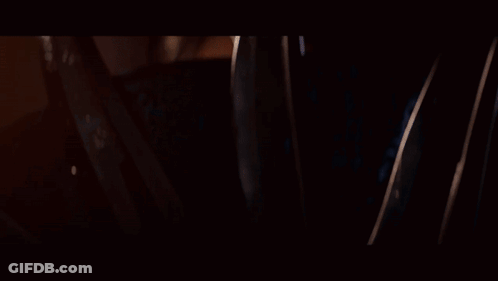 A Close Up Of A Woman Wearing A Blue And Gold Mask GIF