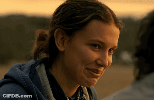 A Close Up Of A Woman Wearing A Blue Hoodie And A Scarf GIF