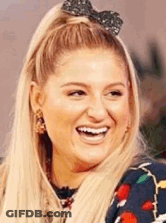 A Close Up Of A Woman Wearing A Bow In Her Hair . GIF