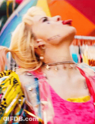 A Close Up Of A Woman Wearing A Choker And Earrings GIF
