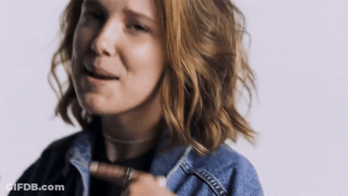 A Close Up Of A Woman Wearing A Denim Jacket And Choker . GIF