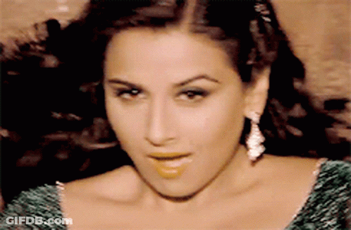A Close Up Of A Woman Wearing A Green Dress GIF
