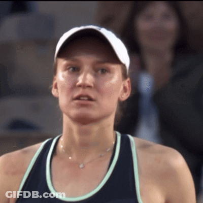 A Close Up Of A Woman Wearing A Hat And A Necklace GIF