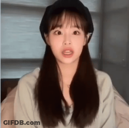 A Close Up Of A Woman Wearing A Hat And A Necklace . GIF