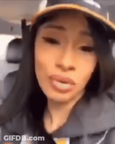A Close Up Of A Woman Wearing A Hat And Making A Funny Face . GIF