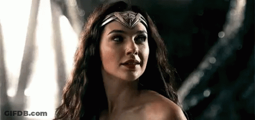 A Close Up Of A Woman Wearing A Headband And A Crown . GIF