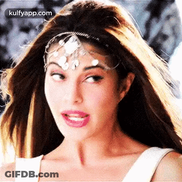 A Close Up Of A Woman Wearing A Headband On Her Forehead . GIF