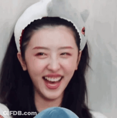 A Close Up Of A Woman Wearing A Headband With A Shark On It . GIF