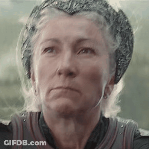 A Close Up Of A Woman Wearing A Helmet And A Crown . GIF