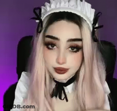 A Close Up Of A Woman Wearing A Maid Costume And A Hat . GIF