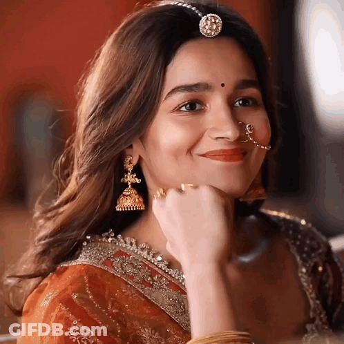 A Close Up Of A Woman Wearing A Nose Ring And Earrings GIF