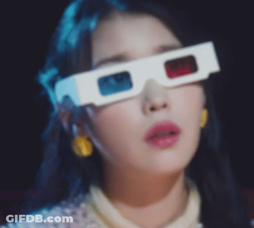 A Close Up Of A Woman Wearing A Pair Of 3D Glasses . GIF