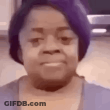 A Close Up Of A Woman Wearing A Purple Hat And A Blue Shirt . GIF