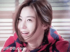 A Close Up Of A Woman Wearing A Red And Blue Blanket GIF