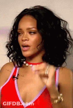 A Close Up Of A Woman Wearing A Red And Purple Top GIF