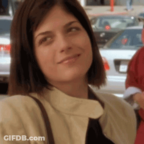 A Close Up Of A Woman Wearing A Tie And A Jacket GIF