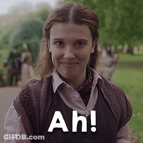 A Close Up Of A Woman Wearing A Vest And Smiling With The Words Ah ! GIF