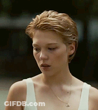 A Close Up Of A Woman Wearing A White Tank Top And Necklace GIF