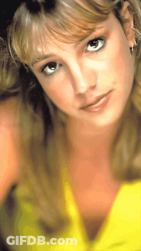 A Close Up Of A Woman Wearing A Yellow Shirt GIF