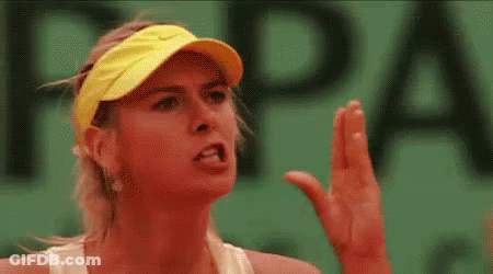 A Close Up Of A Woman Wearing A Yellow Visor And A White Tank Top On A Tennis Court . GIF