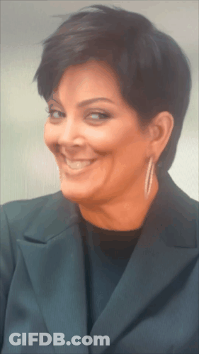 A Close Up Of A Woman Wearing Earrings And A Black Jacket GIF