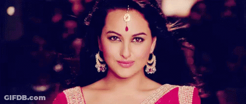 A Close Up Of A Woman Wearing Earrings And A Maang Tikka . GIF