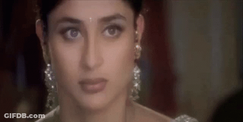 A Close Up Of A Woman Wearing Earrings And A White Dress . GIF