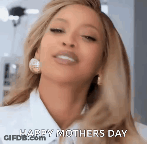 A Close Up Of A Woman Wearing Earrings And A White Shirt . GIF