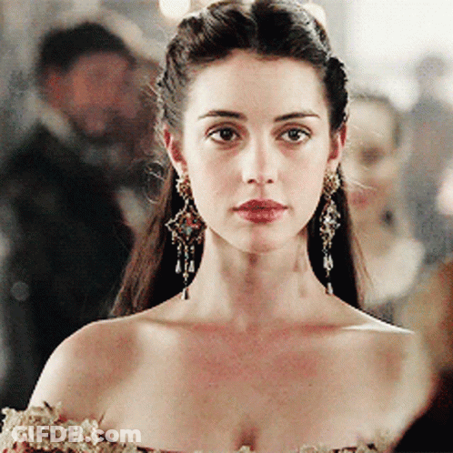 A Close Up Of A Woman Wearing Earrings GIF