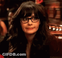 A Close Up Of A Woman Wearing Glasses And A Black Jacket . GIF
