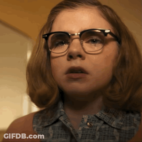 A Close Up Of A Woman Wearing Glasses And A Shirt That Says ' I Love You ' On It GIF