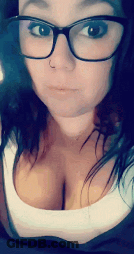 A Close Up Of A Woman Wearing Glasses And A White Shirt GIF