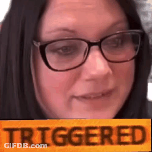 A Close Up Of A Woman Wearing Glasses And A Yellow Sign That Says Triggered . GIF