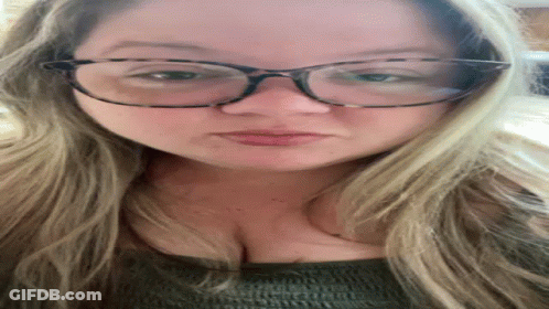 A Close Up Of A Woman Wearing Glasses And Making A Face GIF