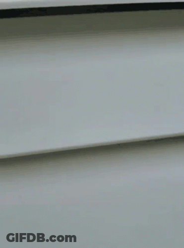 A Close Up Of A Woman Wearing Glasses Looking Out Of A Window GIF