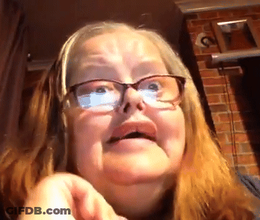 A Close Up Of A Woman Wearing Glasses Making A Face GIF