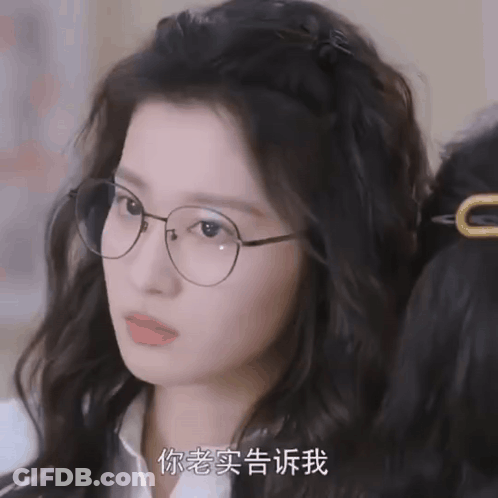 A Close Up Of A Woman Wearing Glasses With Chinese Writing GIF